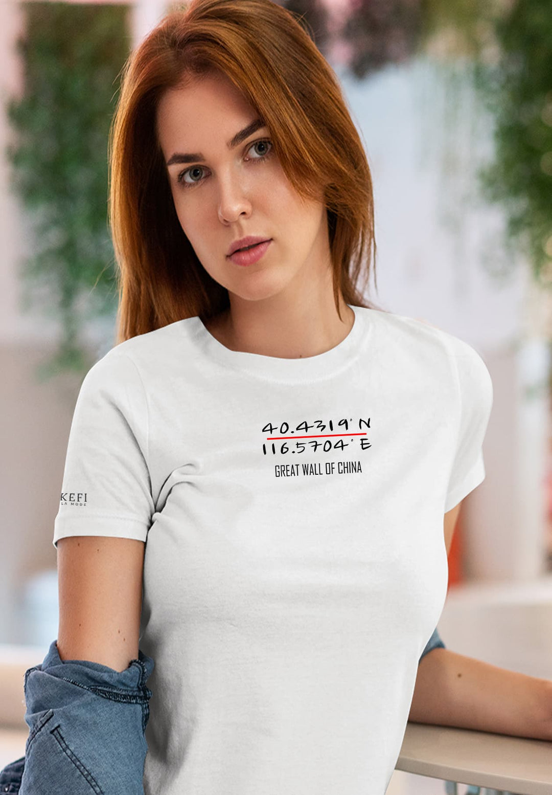 Comfort meets style as a woman sits gracefully, adorned in a white T-shirt beneath a denim shirt.