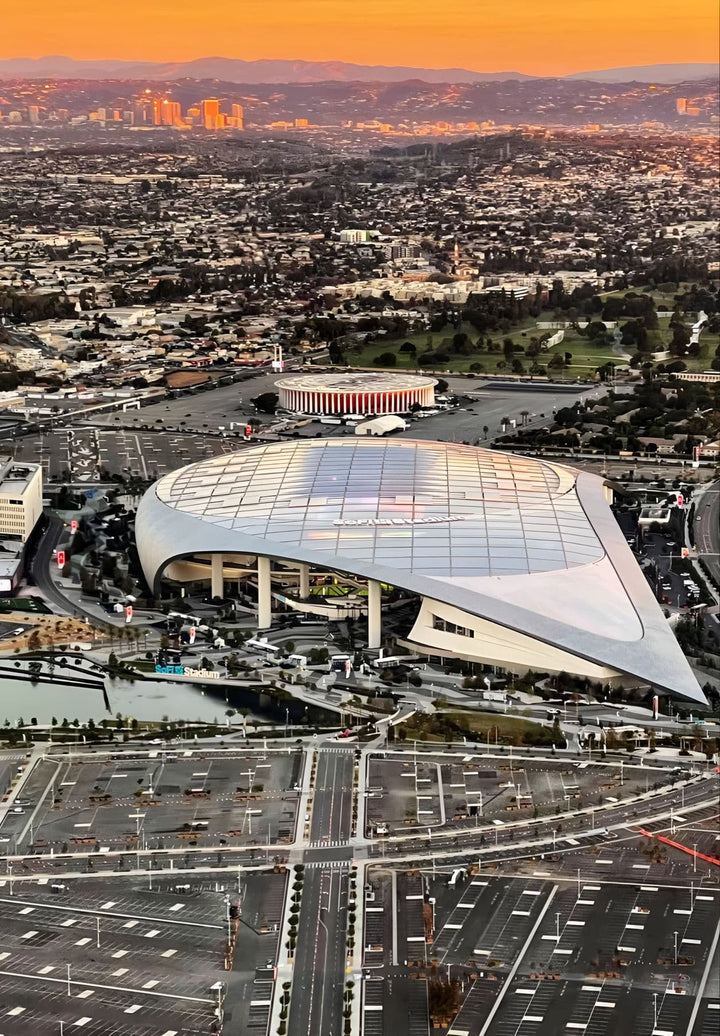From above, the SoFi Stadium in Inglewood, California, sprawls majestically, embodying a modern marvel and a hub of thrilling events, promising excitement and unforgettable moments.