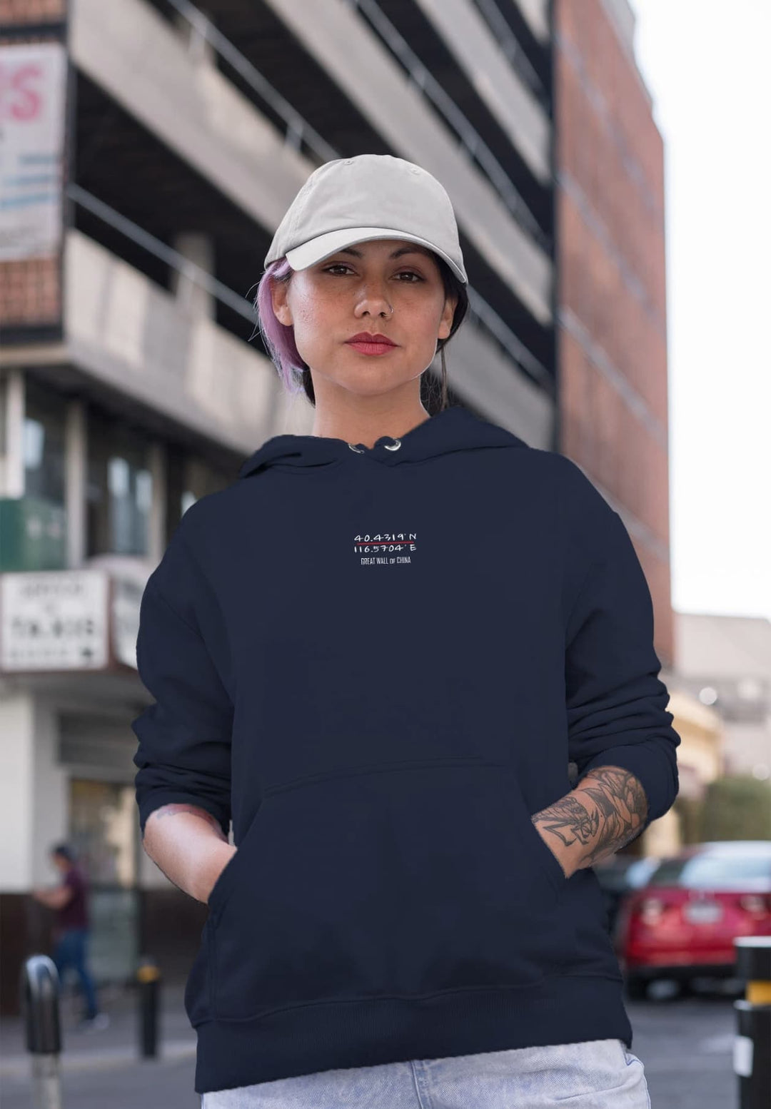 With a hat topping her blue hoodie, the woman exudes a sense of casual street style as she strolls through the city.