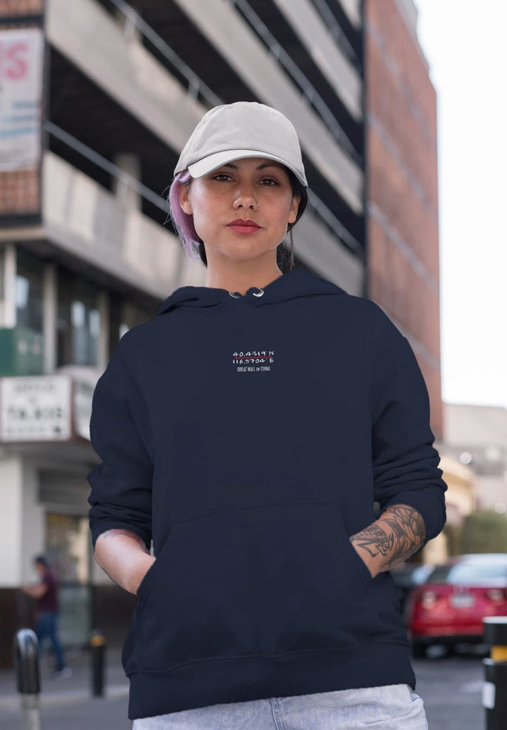 With a hat topping her blue hoodie, the woman exudes a sense of casual street style as she strolls through the city.