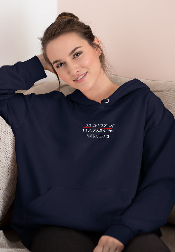 With a relaxed demeanor, the female sitting on the sofa radiates a sense of comfort and style, highlighted by her choice of the blue hooded sweatshirt.