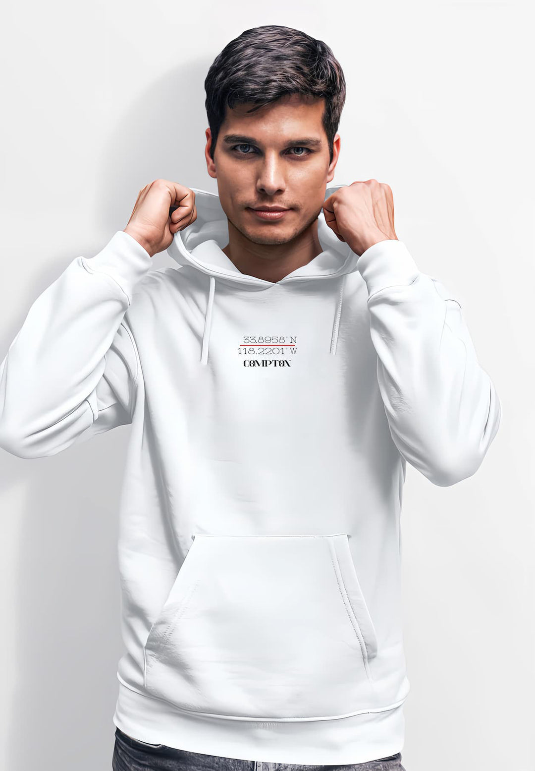 A middle-aged man sporting a white hoodie strikes a pose for the camera as he smiles broadly.