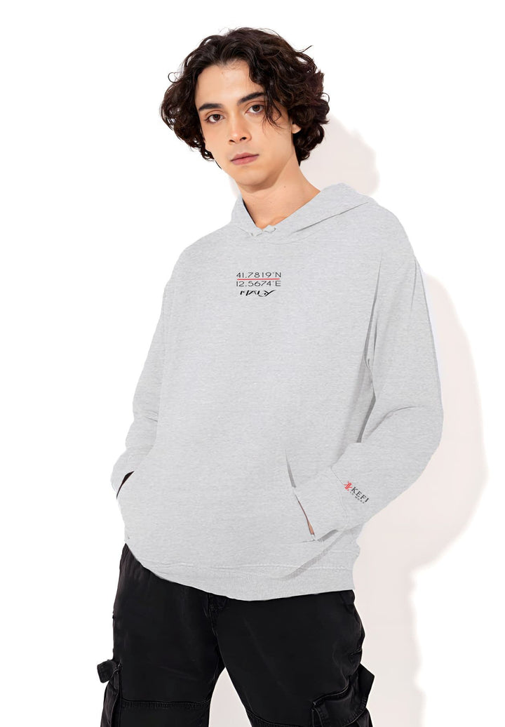 A male model striking a pose while wearing a gray Kefi La Mode hoodie.