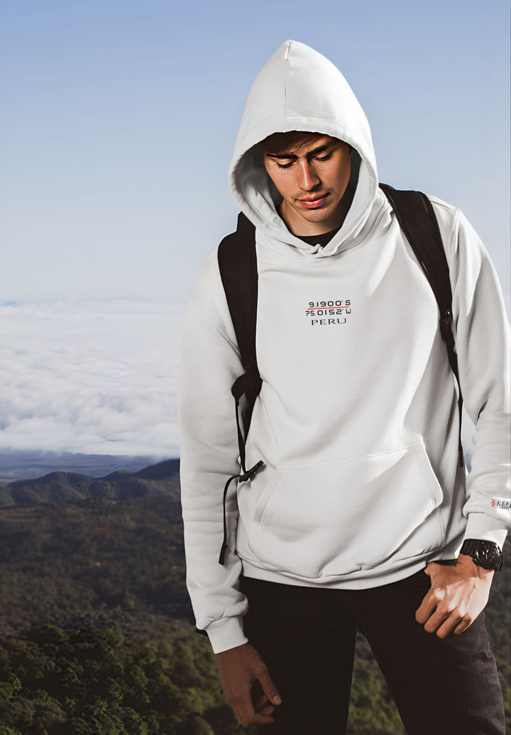 With a sense of sartorial finesse, the man stands tall, attentively with his white Peru hoodie, epitomizing his impeccable taste in fashion.