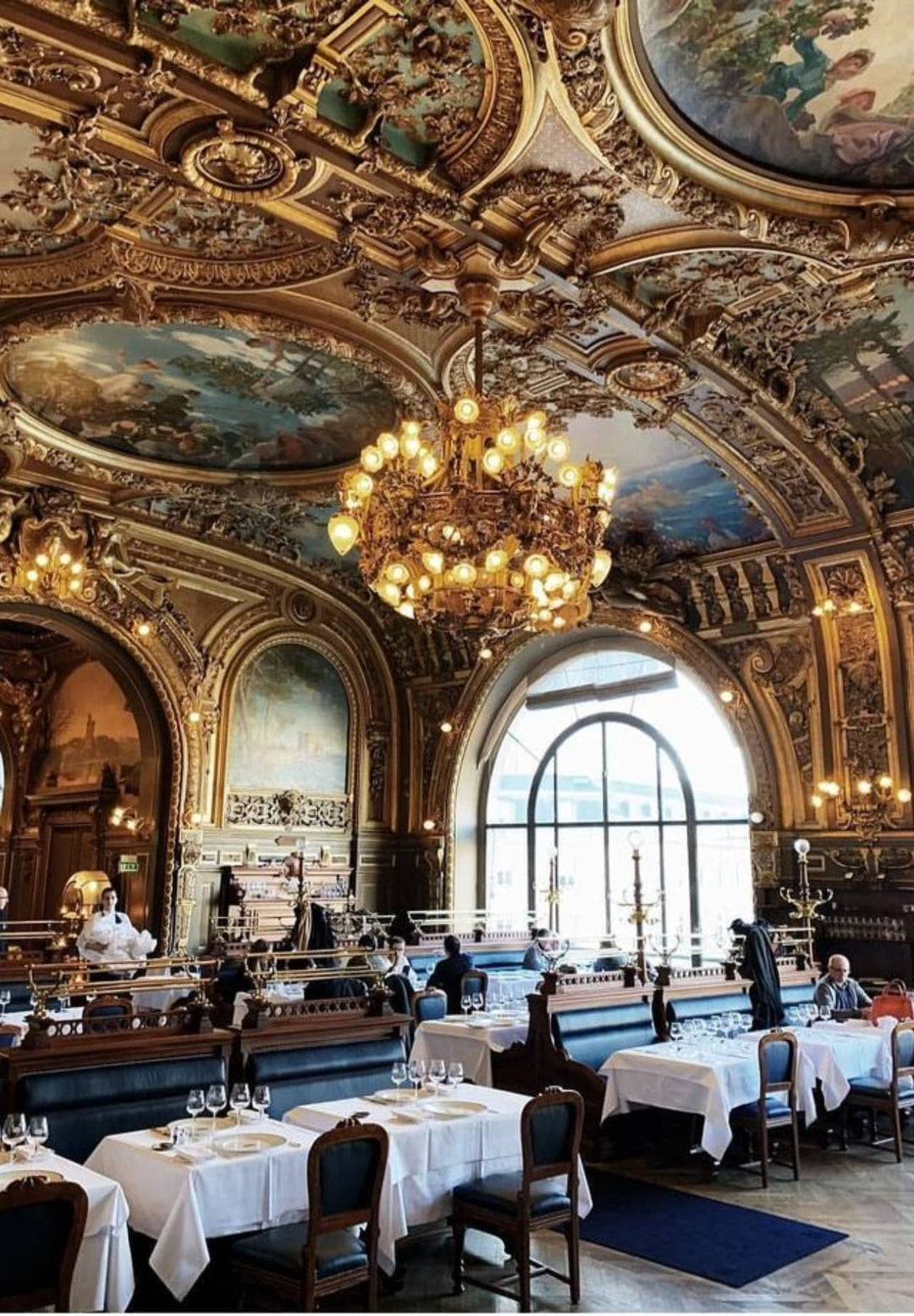 The exquisite interior of Le Train Bleu restaurant in Paris, France.