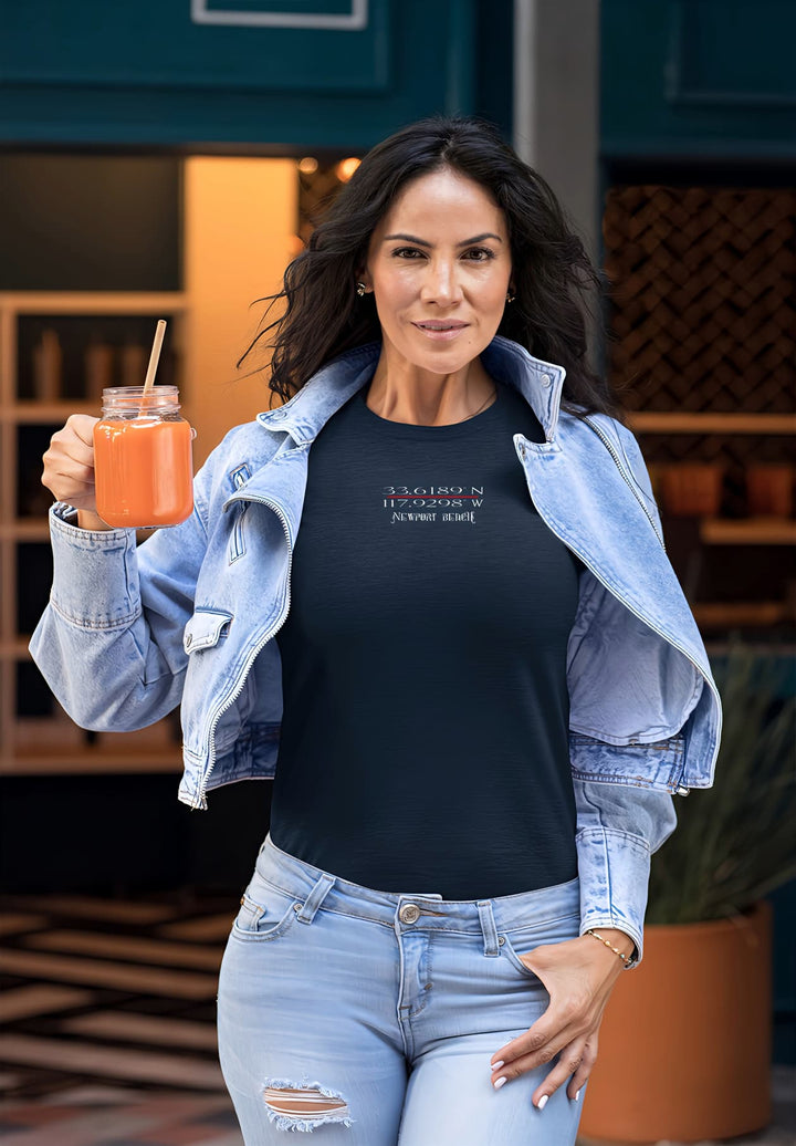   Radiating a carefree vibe, she embraces casual elegance in ripped jeans, a blue t-shirt, and a drink in hand, embodying the spirit of laid-back beauty.