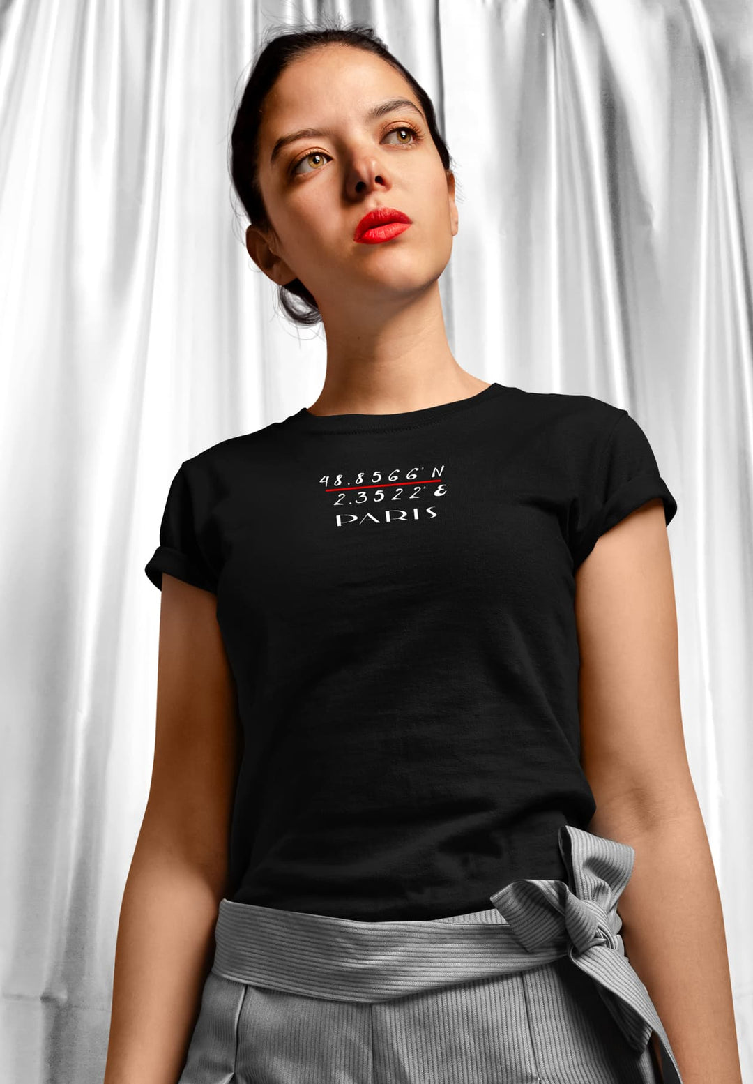 With the allure of midnight, she dons a black t-shirt, her lips adorned in passionate red, a silhouette of confident elegance.