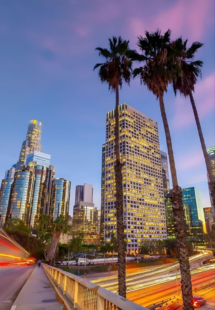 At twilight, observe the cityscape and the freeway in Los Angeles, California.