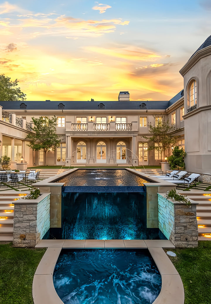 A large Bel-Air mansion with a pool in front of it.