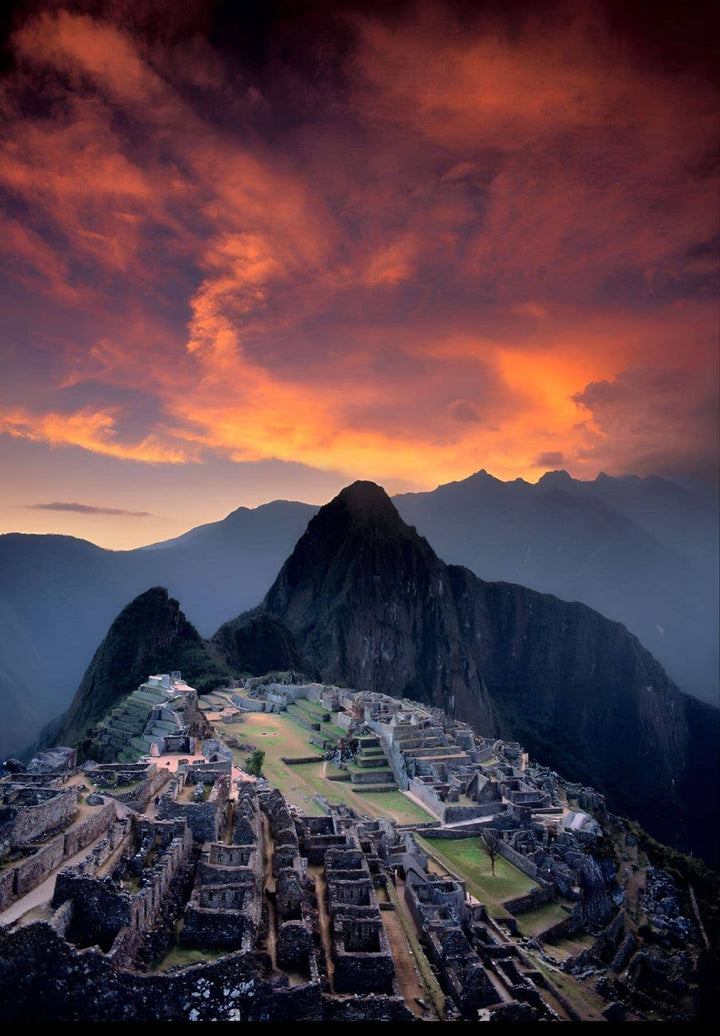 Machu Picchu, a once-in-a-lifetime spectacle that mixes the wonders of nature with ancient human genius, basks in the golden light as the sun gently kisses the Peruvian sky.