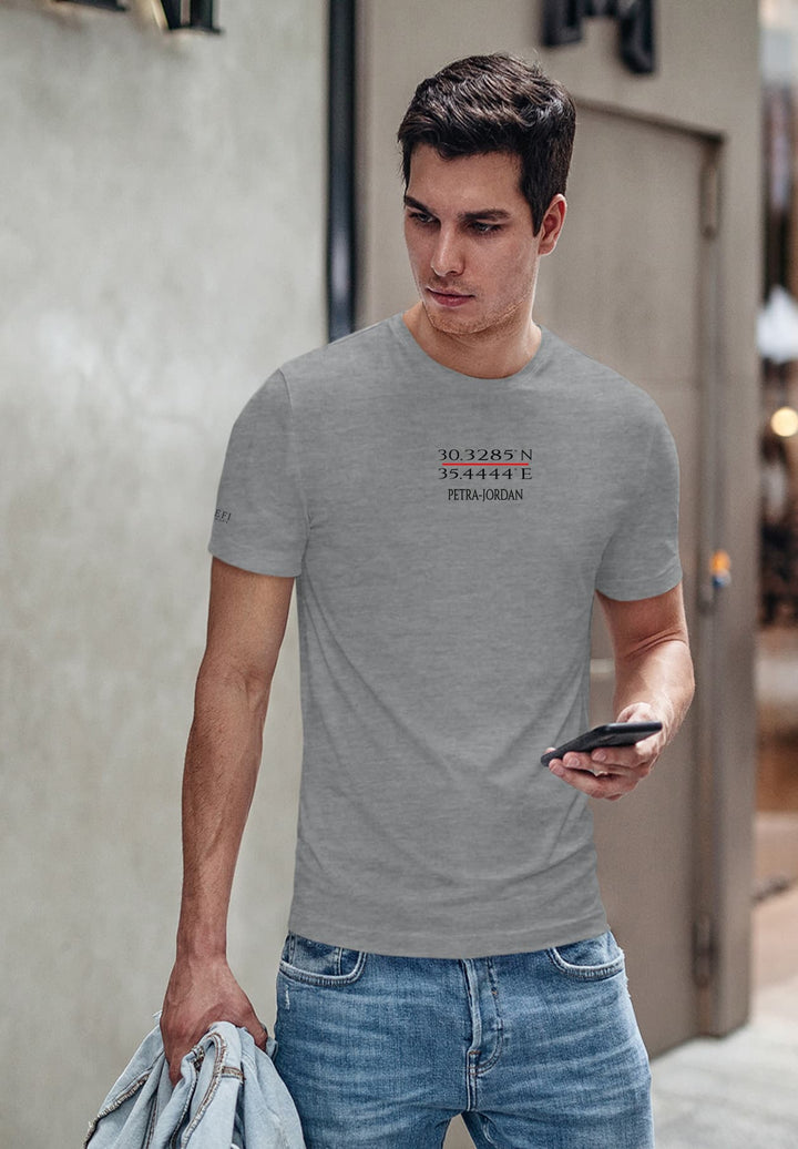 With a gray Petra tee, he blends past and present, phone in hand, a bag of hopes, creating memories anew.