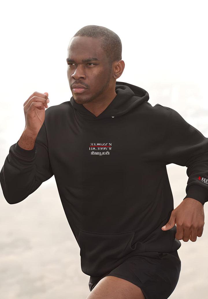 A gentleman out for a run in the early hours of the morning wearing a black hoodie.