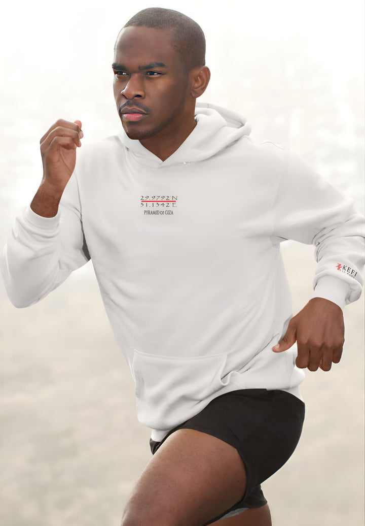 An adult male wearing a Pyramid of Giza white hoodie can be seen running through the fog.
