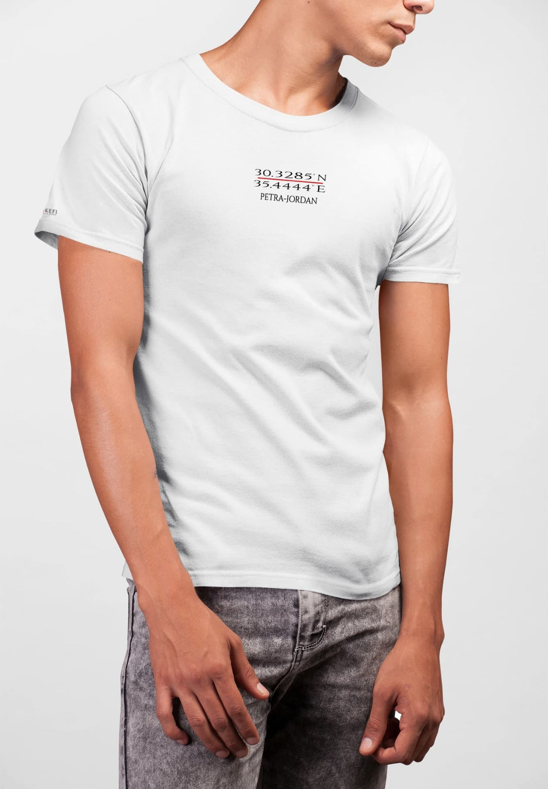Man in a white Petra tee and gray bottoms, he embodies the journey, merging ancient whispers with contemporary strides.