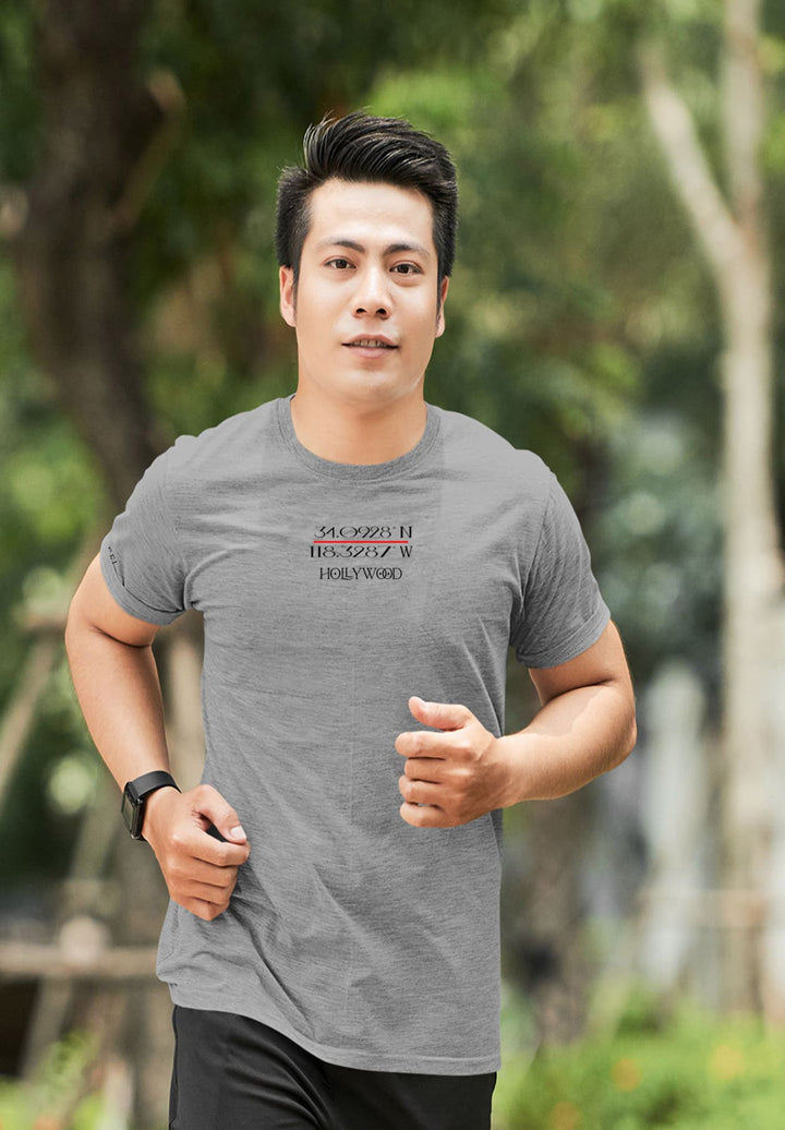 Gray tee, Hollywood bound—the man's run is an emotional journey, the fabric of his shirt woven with aspirations.