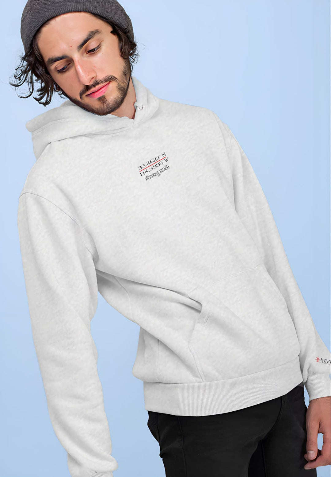 In a display of style, the young man leans and offers a glimpse of the gray Kefi La Mode hoodie.