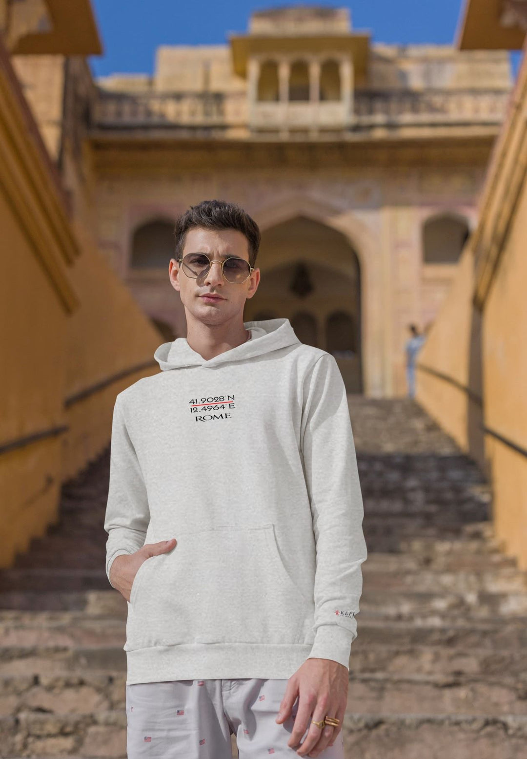 With a perfect blend of modernity and history, the man's gray hoodie showcases Rome GPS coordinates.