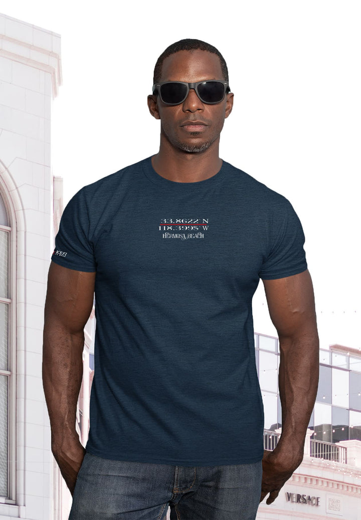 Posing in blue tee, sunglasses shading emotions, hands in pockets echo a silent narrative—the man's portrait, a symphony of style and depth.