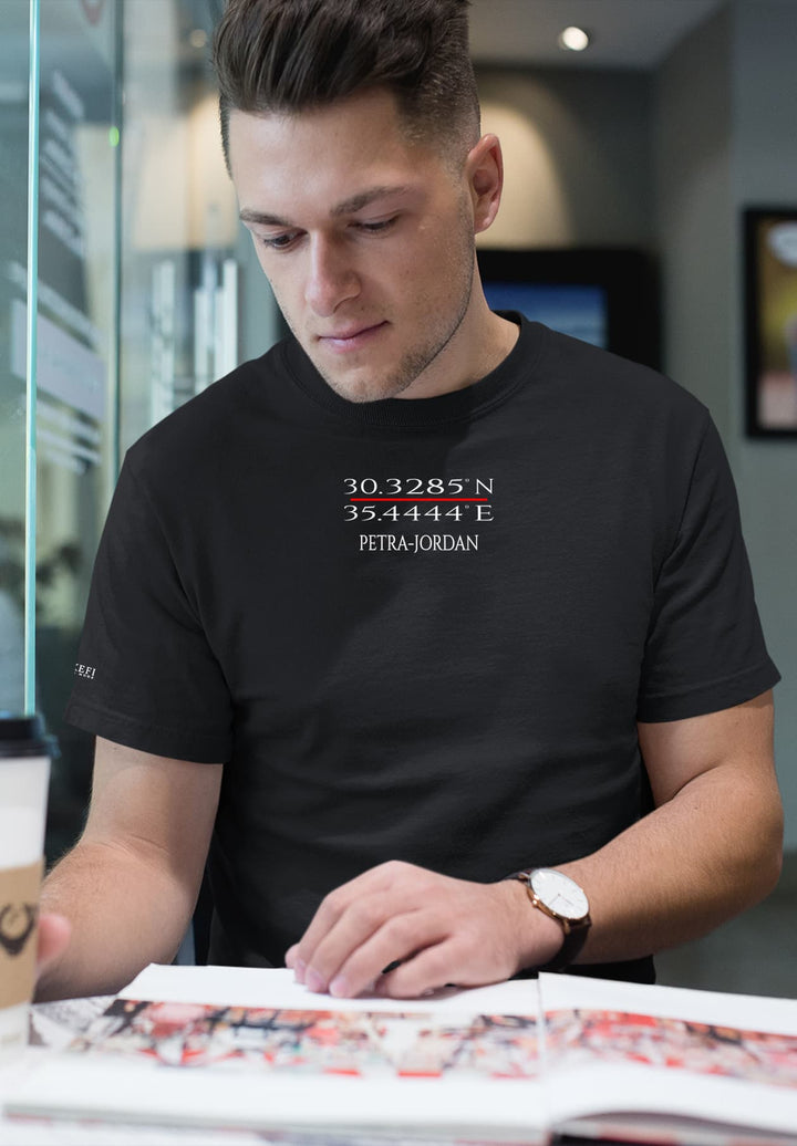 With a watch on his wrist and a black Petra tee, he immerses in stories, each word a journey.