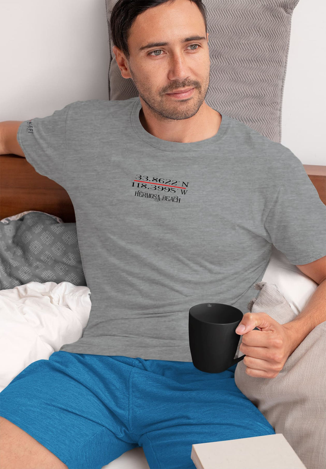 Gray tee, coffee mug, and contemplation—the man's quiet moment unfolds, an emotional journey in the simplicity of morning rituals.