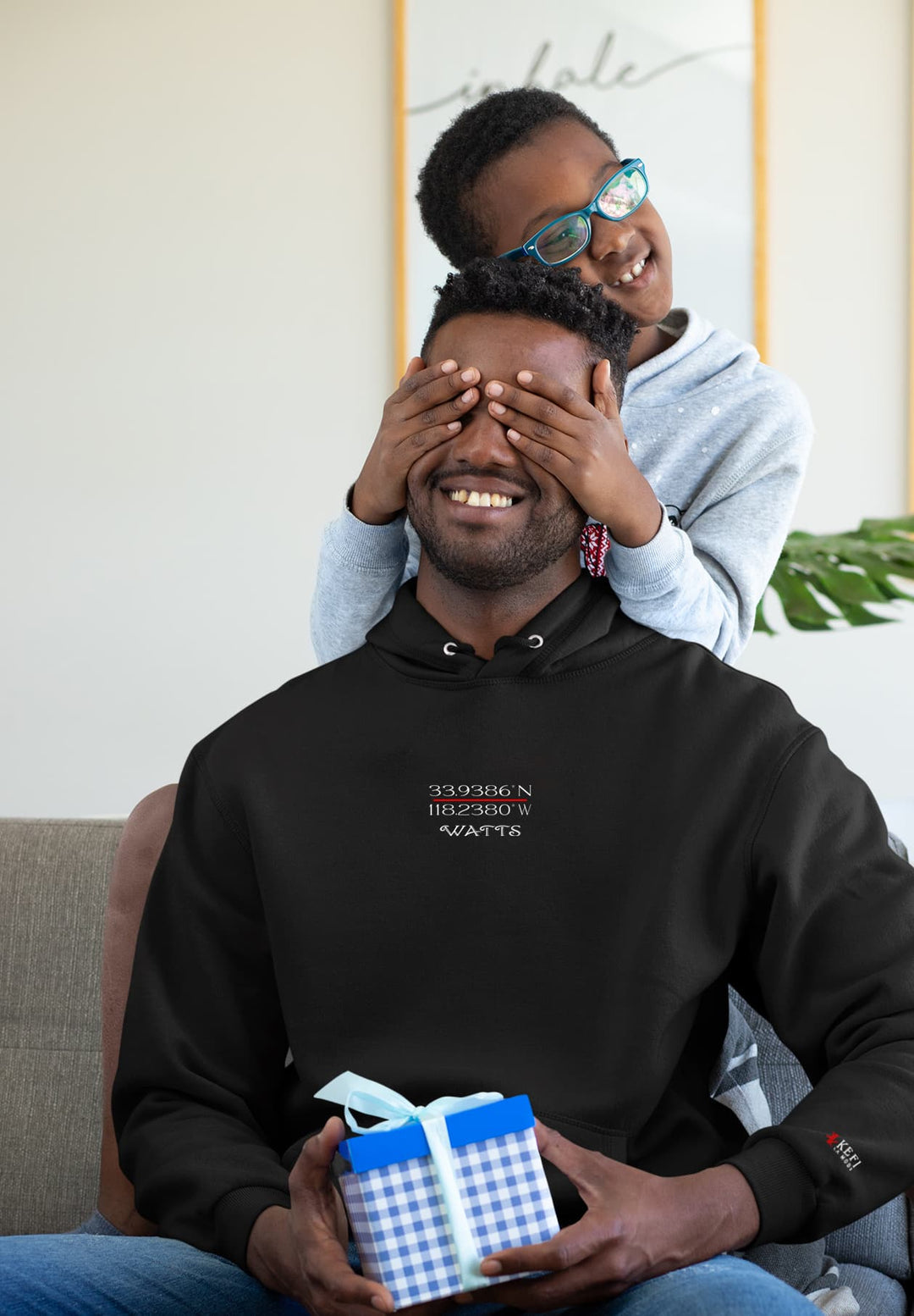 The man's black sweatshirt symbolizes warmth and connection with each chuckle, while the child's pleasure adds pure bliss.