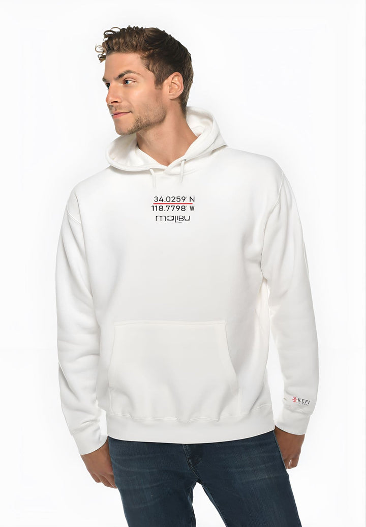 With an effortlessly cool vibe, the man stands in a white sweatshirt showcasing his unique fashion sense.