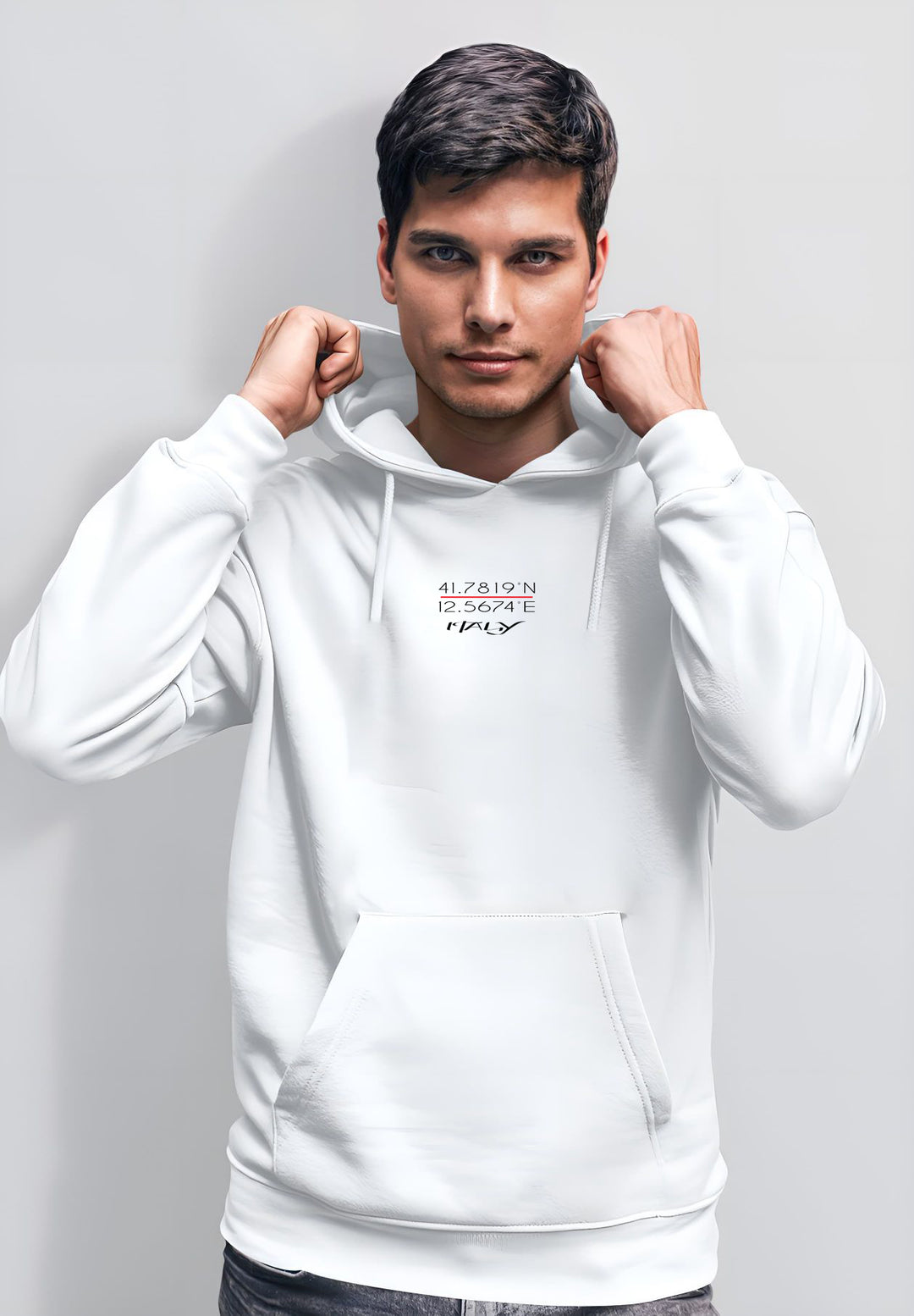 A picture is being taken of a man who is standing still while wearing a white hoodie.
