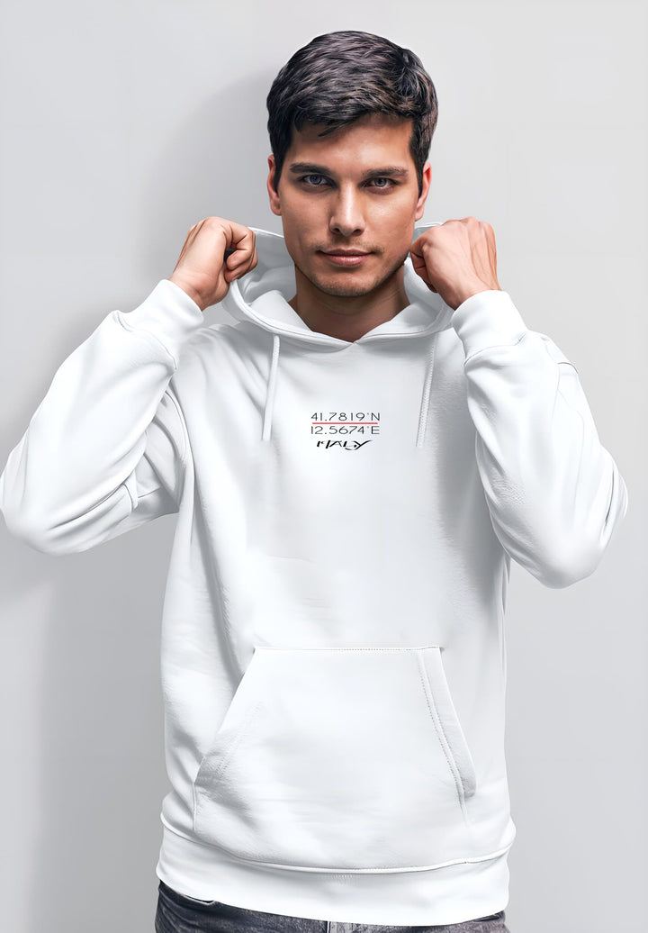 A picture is being taken of a man who is standing still while wearing a white hoodie.