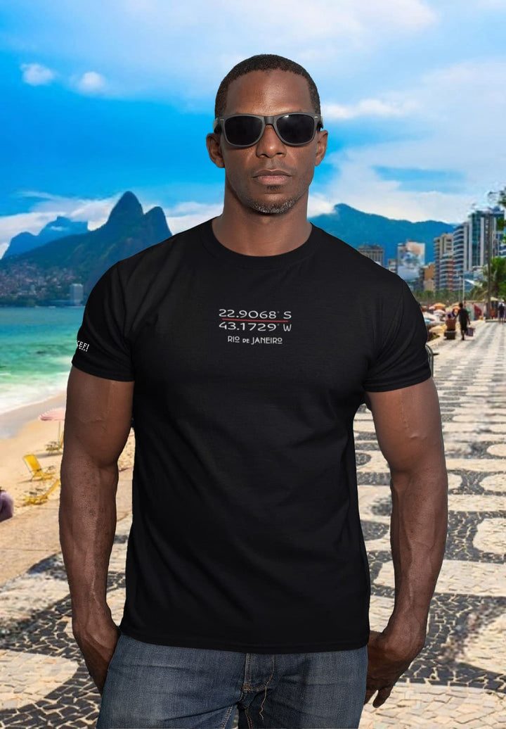Beside the crashing waves, his black tee bears the weight of memories, whispers lost to the salty air.