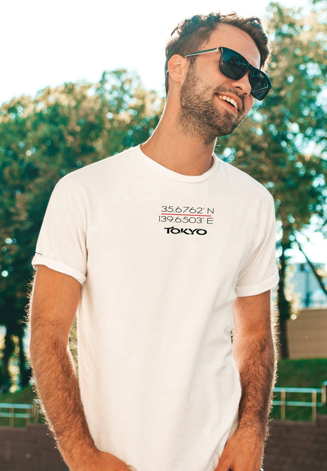 Under the sun's embrace, he stands, his white tee a canvas for moments of warmth and radiant memories.