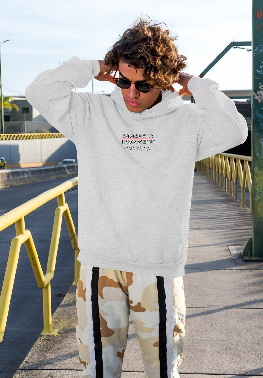 The man exudes West Coast flair, donning a Santa Barbara gray hoodie that echoes the sun-soaked vibes of the region.