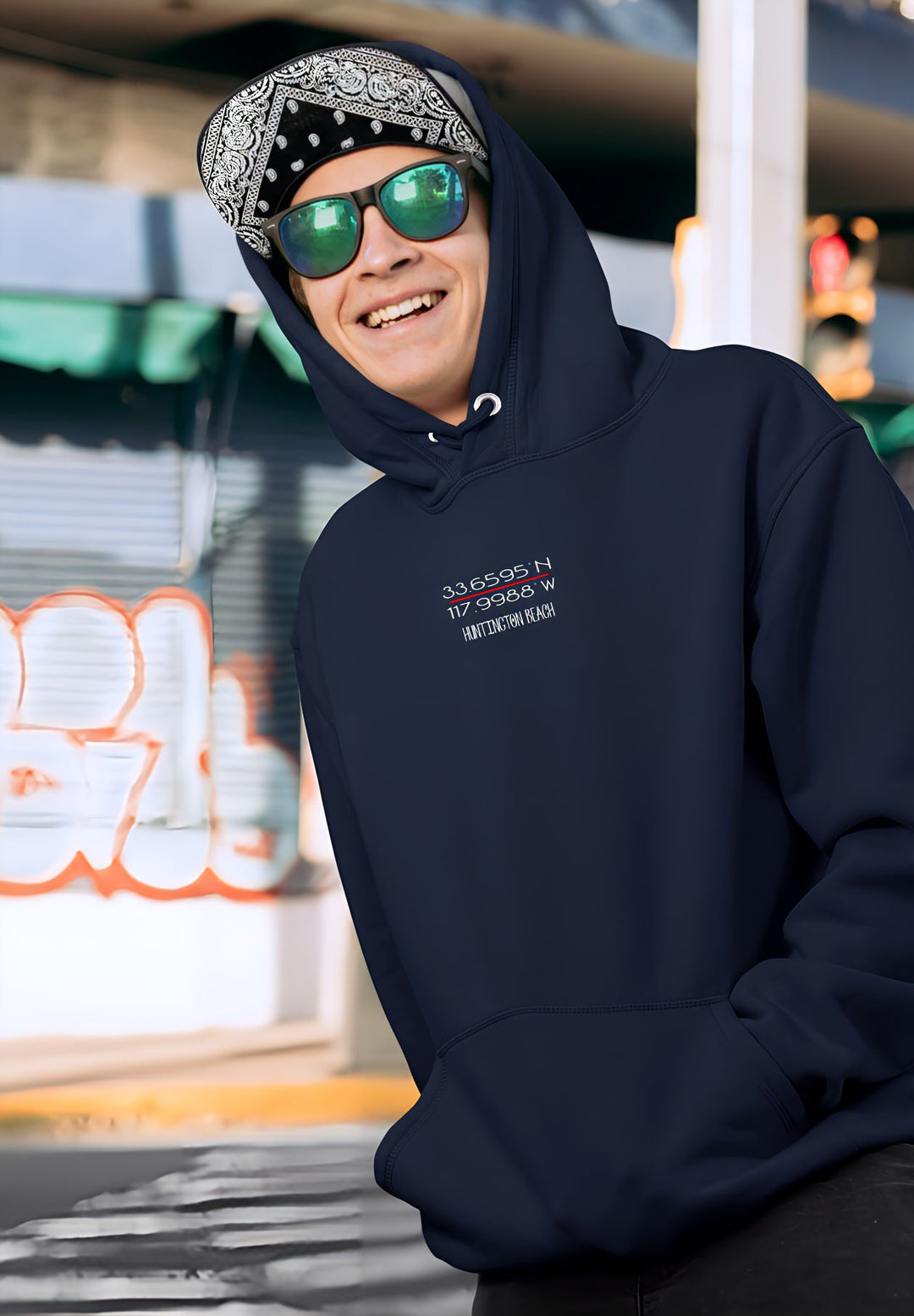 The young man exudes style, donning sunglasses and a navy blue hoodie.