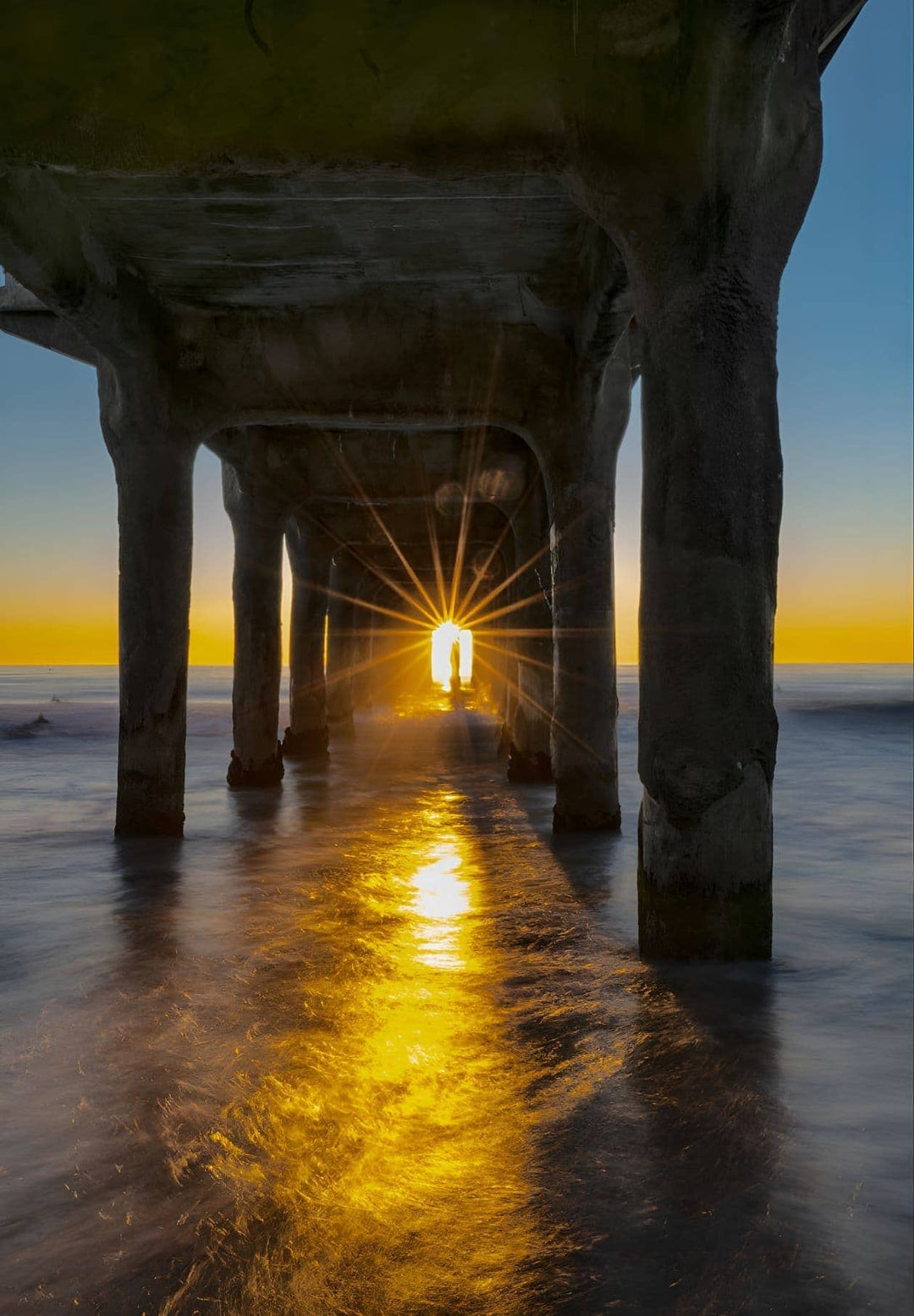 A substantial crowd gathers beneath the Manhattan Beach Pier to see the remarkable event known as "Pierhenge".