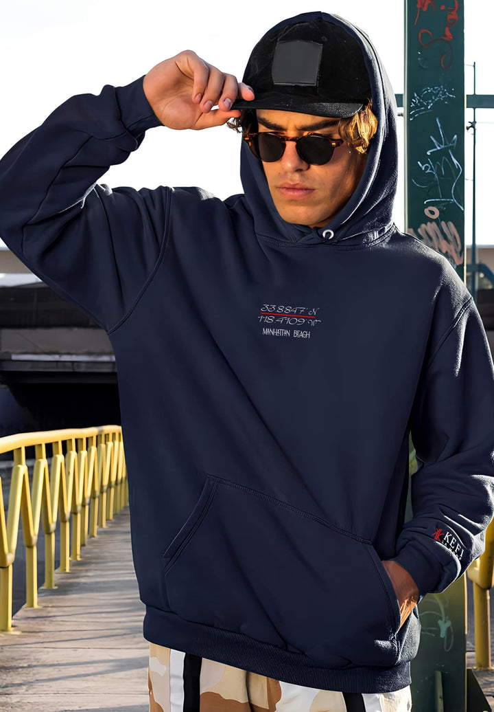 Sporting a navy blue sweatshirt and pants, the man's outfit exudes a perfect blend of casual comfort and fashion-forward style.