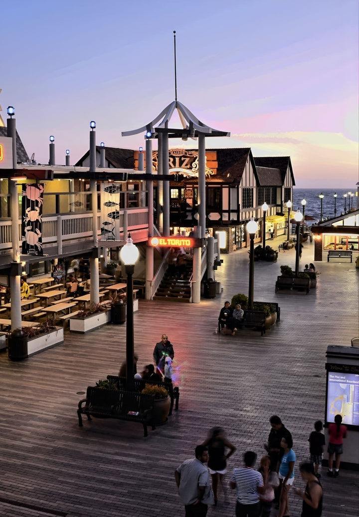 As the sun sets below the horizon, the Redondo Beach Pier is transformed into a picturesque scene of colors at dusk, captivating the viewer.