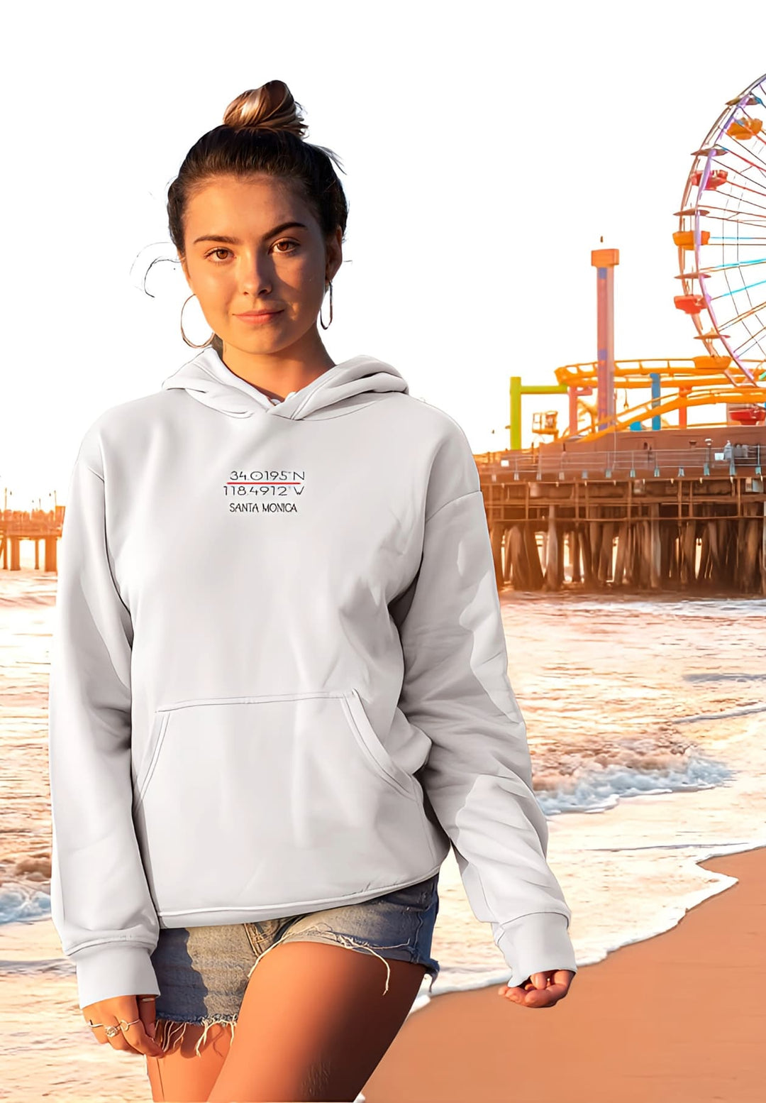 A beautiful girl in a white hoodie graces a Santa Monica Beach sunset. 
