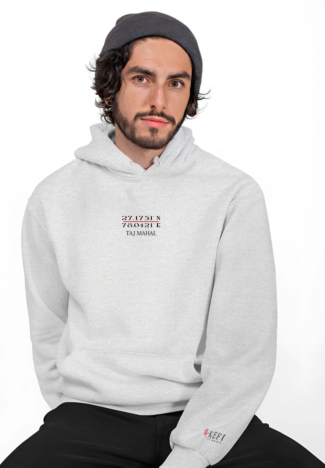 With a masterful blend of attitude and attire, the man's gray Taj Mahal pullover hoodie becomes the centerpiece of his poised pose.