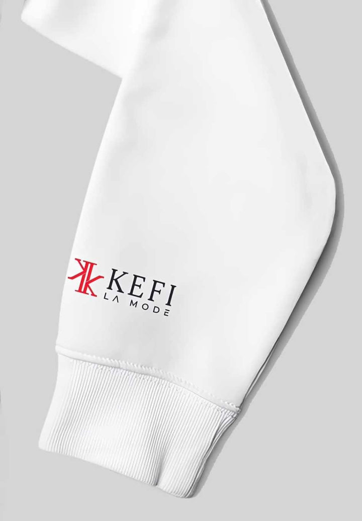 The individual completes a fashionable and contemporary red KEFI La Mode logo on their wrist.