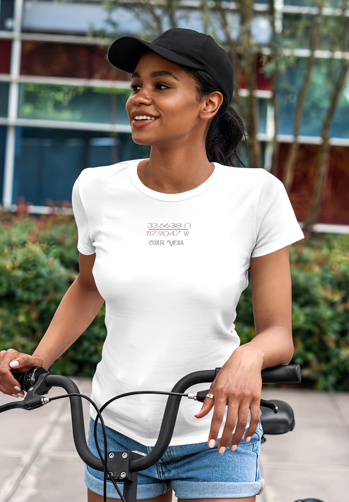 A smiling woman cycles her bike in a white t-shirt, creating a moment of carefree happiness that blends the thrill of a ride with the warmth of a genuine smile.