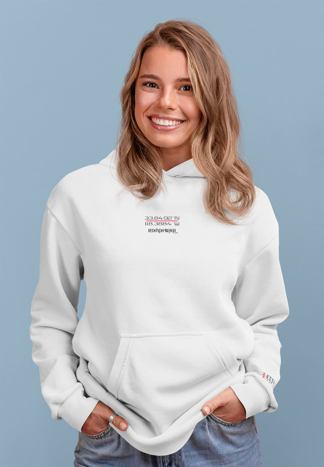 The young woman in the white hoodie creates a joyful fashion moment.