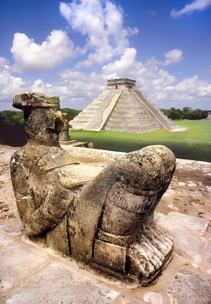 Man-like statue atop a pedestal in front of Chichen Itza's Great Pyramid.