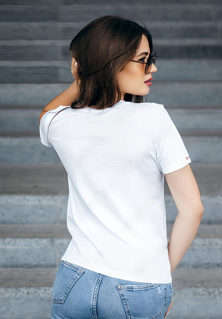 A back-view of a woman in a white T-shirt evokes memories of sunlit mornings and laughter.