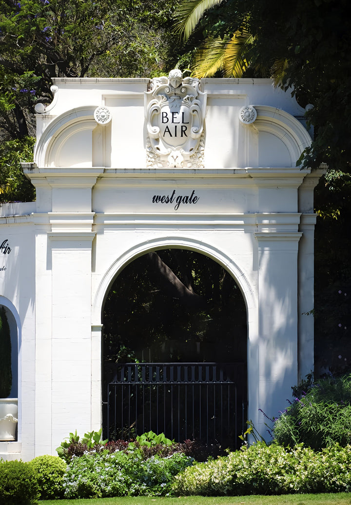 The Bel-Air upscale white west gate entrance building with a black gate in front of it.