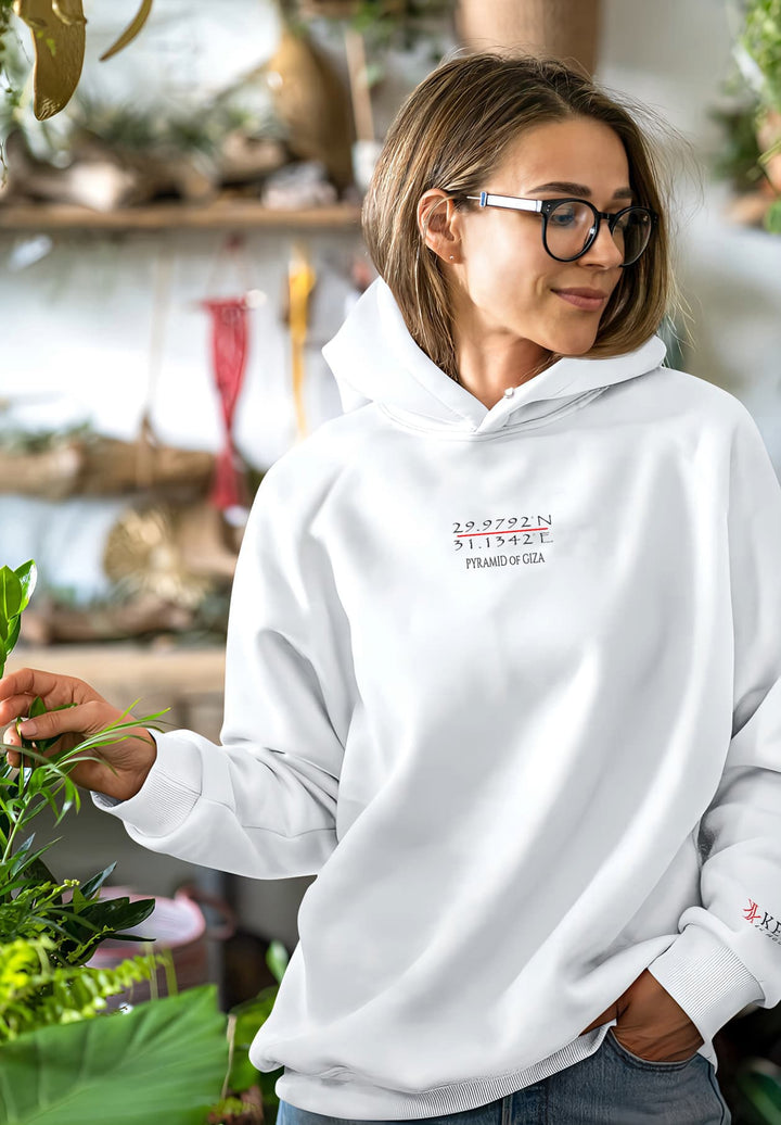 The woman's embrace of nature's beauty while wearing a white hoodie creates a timeless memory of tranquility and peace.