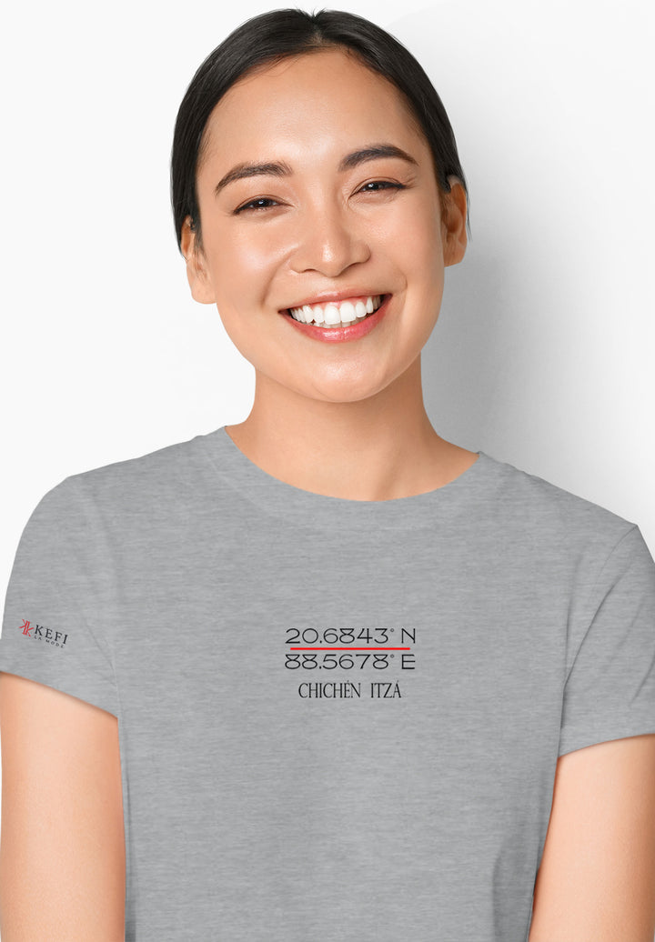 Radiating warmth, a woman in a gray shirt, her smile becoming the embodiment of joy and positivity in a simple yet heartfelt expression.