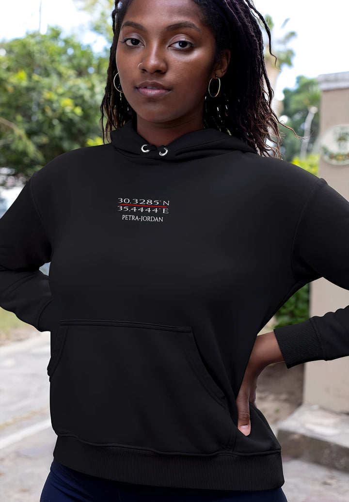 A young woman in a black hoodie captures comfort and style.