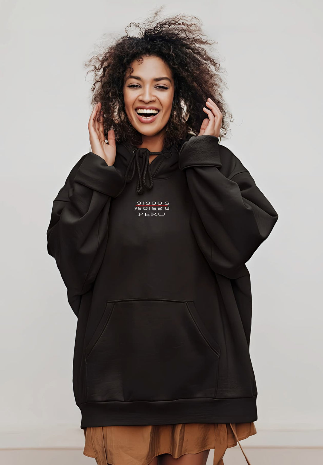 She wears a black Peru hoodie with confidence, reflecting her unique fashion and joyful spirit.