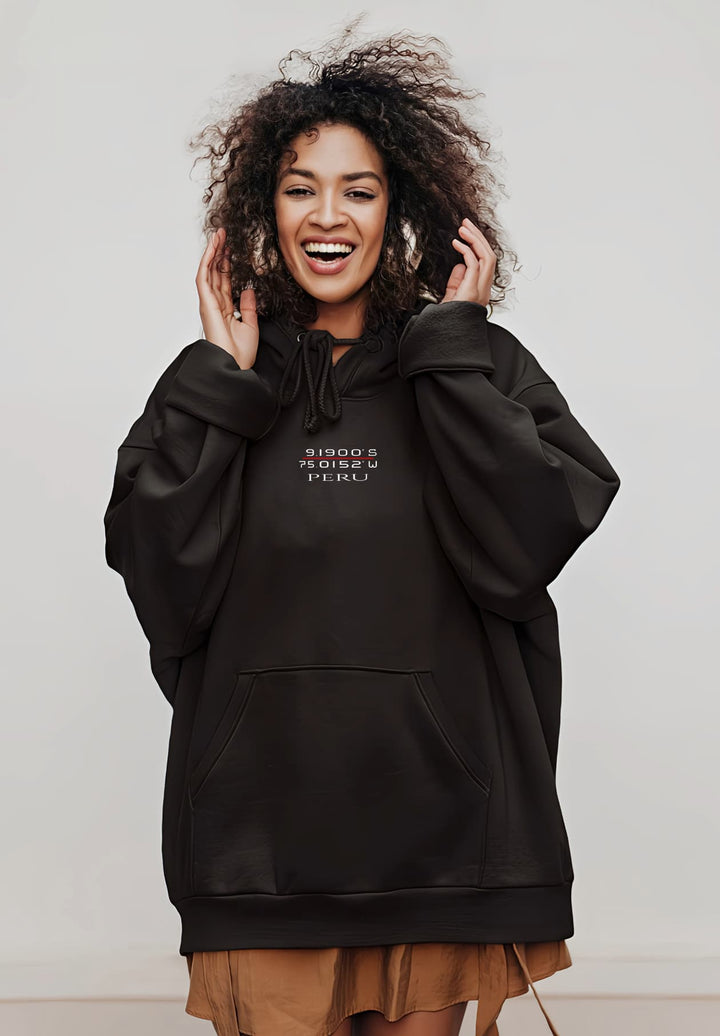She wears a black Peru hoodie with confidence, reflecting her unique fashion and joyful spirit.