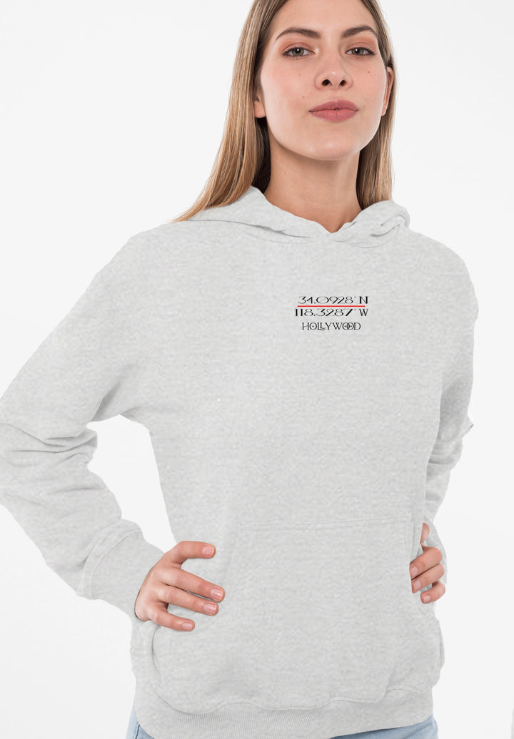 Sporting a gray hoodie adorned with the Hollywood logo, the woman encapsulates a sense of cinematic allure and contemporary style.