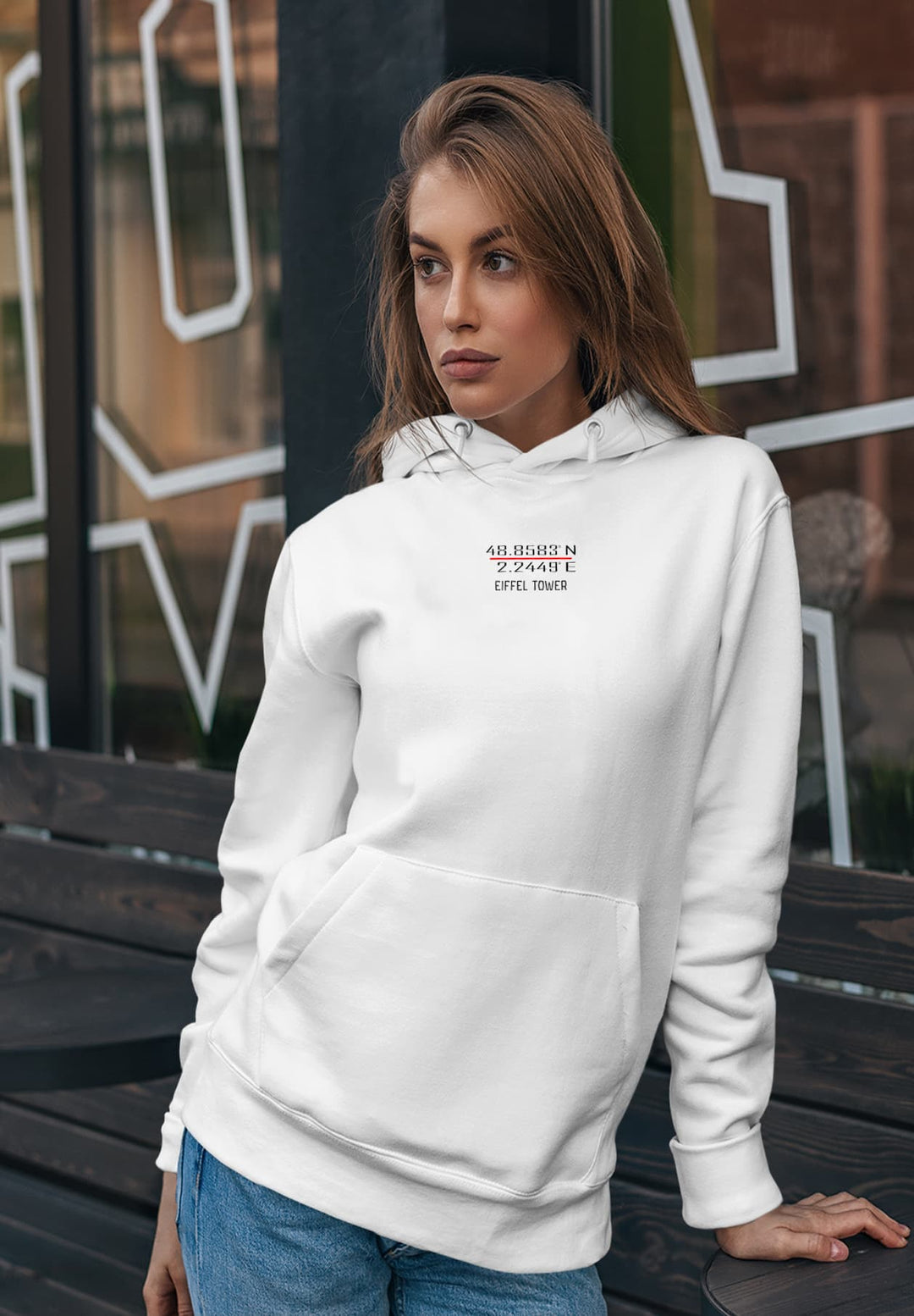 In a quiet moment by the bench, her white hoodie, adorned with the iconic Eiffel Tower coordinates, spoke of an understated elegance intertwined with the romance of Paris.
